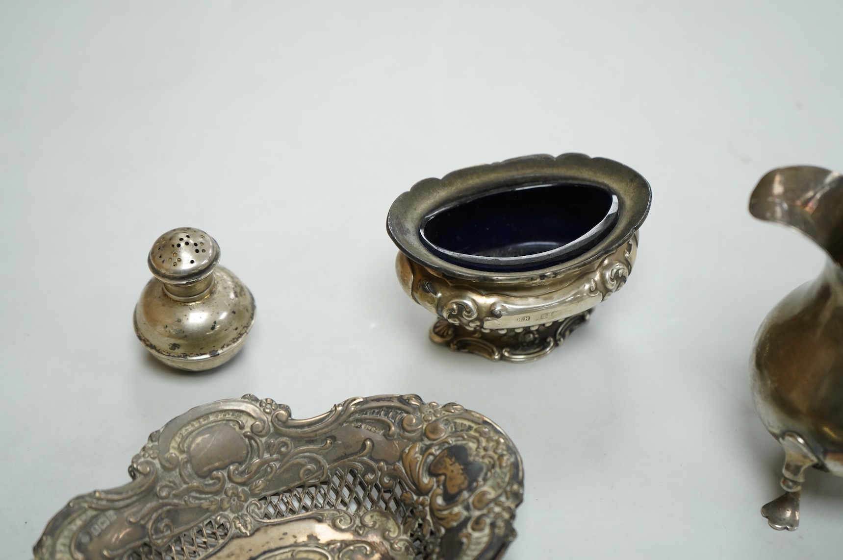 A collection of small silver, including a George III cream jug, London, 1762, 88mm, a George V sugar caster, small five bar toastrack, pair of bonbon dishes, pepperette, dish, two condiment spoons and mustard pot, togeth